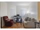 Comfortable living room with a recliner, sofa, and a computer desk by the windows at 1298 Russellville St, North Port, FL 34288