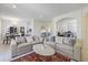 Open concept living space connecting the dining area with comfortable sofas and stylish decor at 1298 Russellville St, North Port, FL 34288