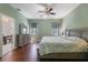 Spacious main bedroom with a ceiling fan and ample natural light from the windows at 1298 Russellville St, North Port, FL 34288