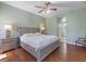 Spacious main bedroom with a ceiling fan, and hardwood floors at 1298 Russellville St, North Port, FL 34288