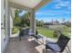 Cozy screened patio with seating, offering a serene view of the landscaped backyard at 1298 Russellville St, North Port, FL 34288