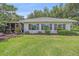 Well-maintained backyard featuring lush green grass and manicured landscaping at 1432 Colony Pl, Venice, FL 34292