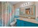 Stylish bathroom featuring blue walls, ocean-themed decor, and granite countertops at 1432 Colony Pl, Venice, FL 34292