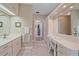 Bathroom featuring a vanity with a sink, a lighted mirror, and a separate dressing area with a chair at 1432 Colony Pl, Venice, FL 34292