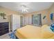 Bright bedroom with a ceiling fan, decorative items, and a large closet at 1432 Colony Pl, Venice, FL 34292