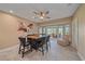 Open dining room with a modern table, stylish chairs, tile floors, and outdoor views at 1432 Colony Pl, Venice, FL 34292
