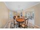 Elegant dining room with a chandelier, hardwood floors, and decorative buffet at 1432 Colony Pl, Venice, FL 34292