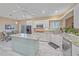 Bright, modern kitchen features an island, stainless steel appliances, and tile floors at 1432 Colony Pl, Venice, FL 34292