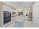 Modern kitchen with white cabinets, stainless steel appliances, and a large kitchen island at 1432 Colony Pl, Venice, FL 34292