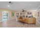 Bright living room features hardwood floors, a ceiling fan, a fireplace, and neutral walls at 1432 Colony Pl, Venice, FL 34292