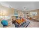 Inviting living room featuring comfortable sofa, decorative pillows, wooden floor, and large windows at 1432 Colony Pl, Venice, FL 34292