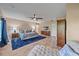 Large main bedroom with hardwood floors, ceiling fan, comfortable seating, and ample storage at 1432 Colony Pl, Venice, FL 34292