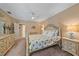 Serene main bedroom featuring a four-poster bed, soft lighting, and neutral decor at 1432 Colony Pl, Venice, FL 34292