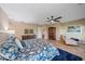 Beautiful main bedroom featuring hardwood floors, ceiling fan, and a comfortable seating area at 1432 Colony Pl, Venice, FL 34292