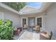 A cozy, covered front porch area with four chairs provides a relaxing outdoor space at 1432 Colony Pl, Venice, FL 34292