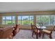 Bright sun room with comfortable seating and bright view of a green landscape at 1432 Colony Pl, Venice, FL 34292