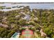 Aerial view of a neighborhood featuring tennis courts, swimming pool, and boat marina at 1629 Pelican Cove Rd # 138A, Sarasota, FL 34231