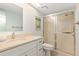 Clean bathroom featuring a shower with sliding glass doors, white vanity, and sink at 1629 Pelican Cove Rd # 138A, Sarasota, FL 34231