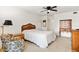 Comfortable bedroom with queen bed, dresser, and ample natural light at 1629 Pelican Cove Rd # 138A, Sarasota, FL 34231