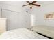 Bright bedroom featuring two twin beds, a ceiling fan, and ample closet space at 1629 Pelican Cove Rd # 138A, Sarasota, FL 34231