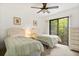 Charming bedroom with two twin beds, ceiling fan, and large window for natural light at 1629 Pelican Cove Rd # 138A, Sarasota, FL 34231