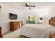 Bright bedroom with a comfy bed, a dresser, and a sliding glass door to the patio at 1629 Pelican Cove Rd # 138A, Sarasota, FL 34231