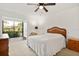 Light-filled bedroom featuring a queen-sized bed and access to the screened patio at 1629 Pelican Cove Rd # 138A, Sarasota, FL 34231