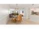 Open dining area with modern lighting and a view to the open living room and updated kitchen at 1629 Pelican Cove Rd # 138A, Sarasota, FL 34231