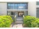 Charming home exterior with a well-maintained facade and inviting entryway surrounded by green bushes at 1629 Pelican Cove Rd # 138A, Sarasota, FL 34231
