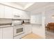 Bright kitchen features white cabinetry, tiled backsplash and modern appliances at 1629 Pelican Cove Rd # 138A, Sarasota, FL 34231