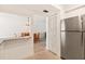 Modern kitchen connects to a dining area, features stainless steel appliances, and neutral tile flooring at 1629 Pelican Cove Rd # 138A, Sarasota, FL 34231