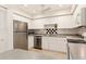 Contemporary kitchen featuring stainless steel appliances and ample white cabinets at 1629 Pelican Cove Rd # 138A, Sarasota, FL 34231