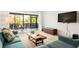 Cozy living room featuring a blue sofa, a wooden coffee table, and screened patio at 1629 Pelican Cove Rd # 138A, Sarasota, FL 34231