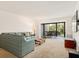 Inviting living room with comfortable seating and view to the screened outdoor patio at 1629 Pelican Cove Rd # 138A, Sarasota, FL 34231