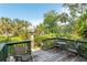 Relaxing outdoor patio with lush greenery and a charming seating area perfect for entertaining guests at 1629 Pelican Cove Rd # 138A, Sarasota, FL 34231