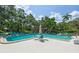 Large community pool with lounge chairs, perfect for relaxation and enjoying the sunny weather at 1629 Pelican Cove Rd # 138A, Sarasota, FL 34231