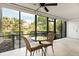 Relaxing screened-in porch featuring a ceiling fan and a cozy seating area with beautiful views at 1629 Pelican Cove Rd # 138A, Sarasota, FL 34231
