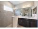 Modern bathroom featuring a double vanity, large mirror, and glass-enclosed shower at 1739 Lake Verona Cir, Bradenton, FL 34211