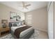 Comfortable bedroom with a gray bed frame, ceiling fan, and a light-filled window at 1739 Lake Verona Cir, Bradenton, FL 34211