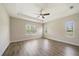 Spacious bedroom featuring a tray ceiling, ceiling fan, and ample natural light from three windows at 1739 Lake Verona Cir, Bradenton, FL 34211