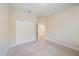 Bedroom has carpet, a closet, neutral walls and leads to another room with tiled floor at 1739 Lake Verona Cir, Bradenton, FL 34211