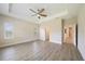 Bright bedroom with tray ceiling, ceiling fan, and wood-look flooring at 1739 Lake Verona Cir, Bradenton, FL 34211