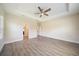 Spacious bedroom with tray ceiling, a ceiling fan, and light wood-look flooring at 1739 Lake Verona Cir, Bradenton, FL 34211