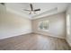 Bright bedroom featuring a tray ceiling, ceiling fan, and large window at 1739 Lake Verona Cir, Bradenton, FL 34211