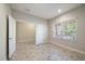 This light filled bedroom with tile floor also includes a closet; note the neutral paint and window bringing the outside in at 1739 Lake Verona Cir, Bradenton, FL 34211