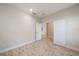 Neutral bedroom with white paneled doors and wood-look flooring at 1739 Lake Verona Cir, Bradenton, FL 34211