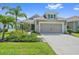 Beautiful home featuring manicured landscaping, a two-car garage, and charming architectural details at 1739 Lake Verona Cir, Bradenton, FL 34211