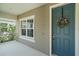 Charming front door with wreath and sidelight window, complemented by a cozy porch at 1739 Lake Verona Cir, Bradenton, FL 34211
