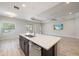 Bright open kitchen featuring a large island with quartz countertops, stainless steel appliances, and ample cabinet space at 1739 Lake Verona Cir, Bradenton, FL 34211