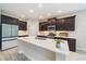 Modern kitchen with dark wood cabinets, a large island, and stainless steel appliances at 1739 Lake Verona Cir, Bradenton, FL 34211